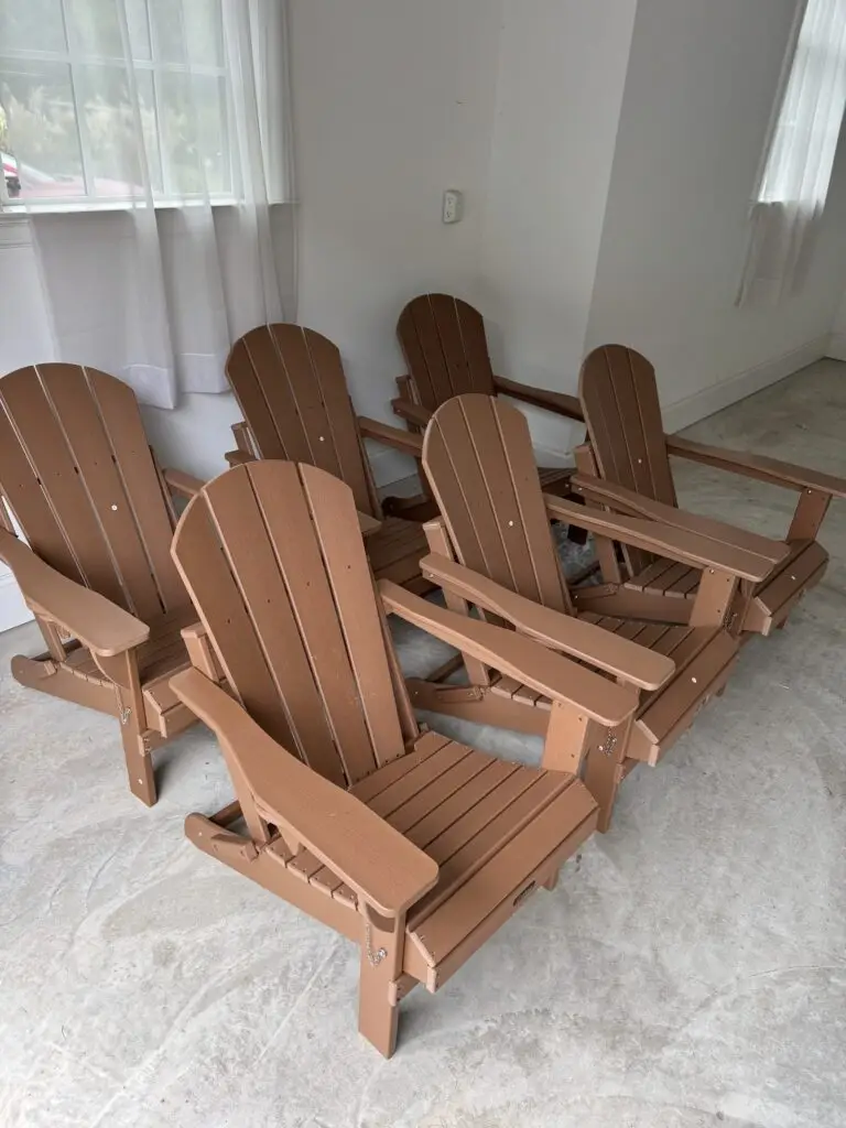 Six wood-tone Adirondack chairs assembled on a patio