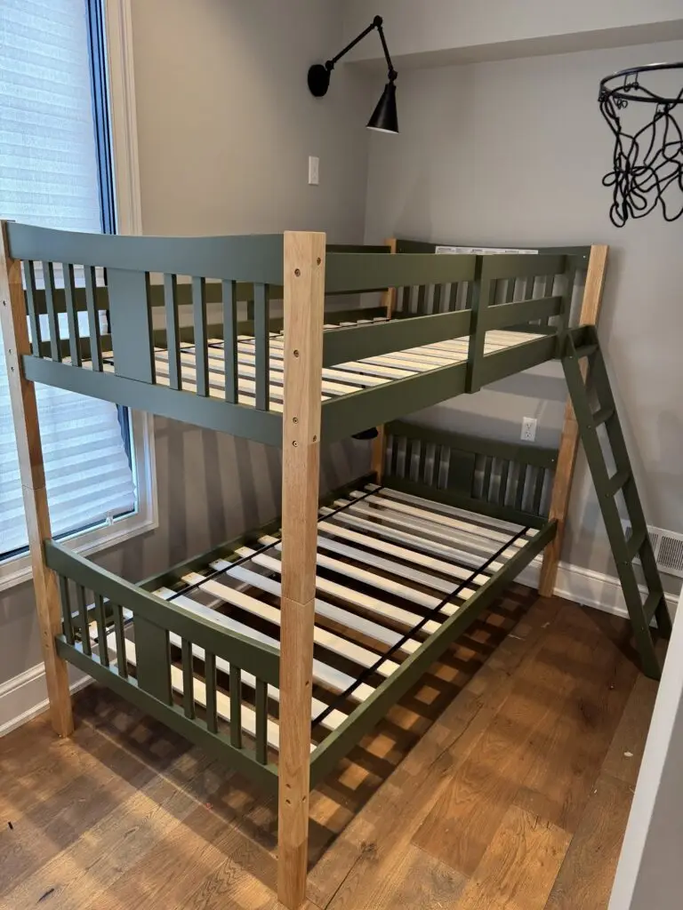 Green and natural wood bunk bed assembled in a kids' bedroom