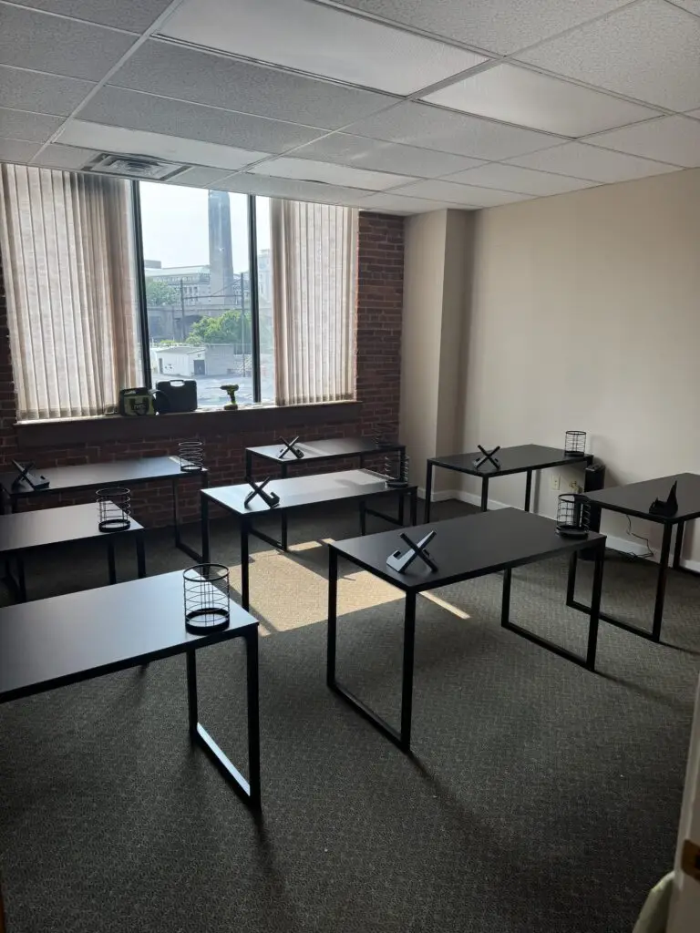 Rows of black office desks assembled for a commercial office space
