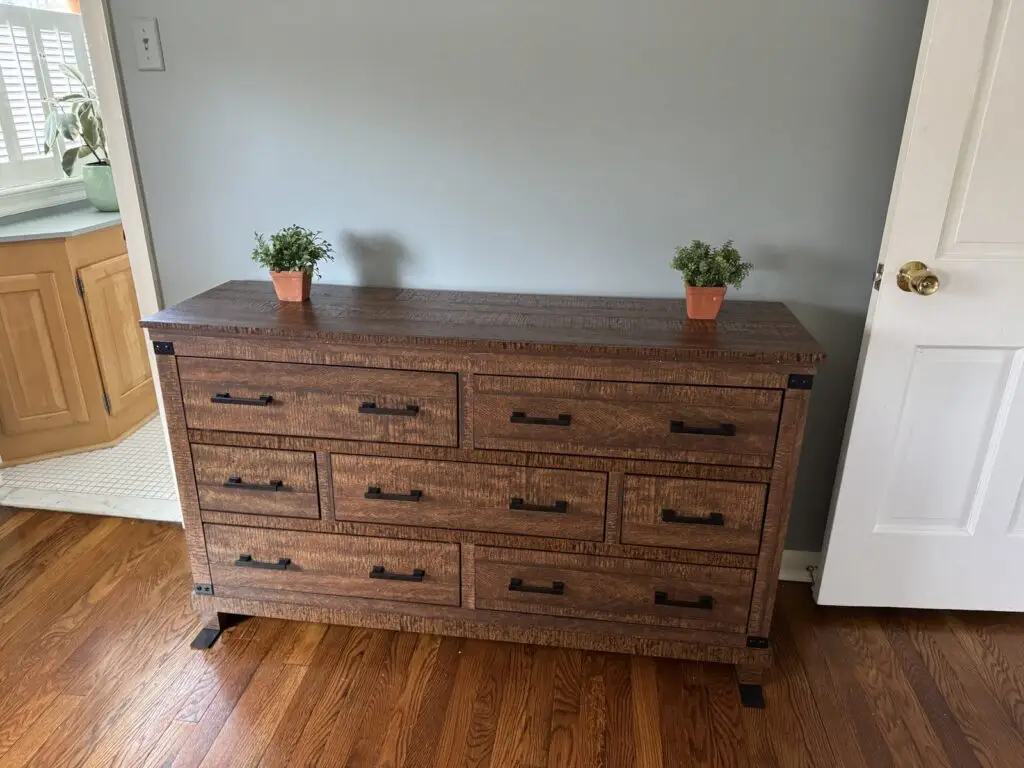 Rustic wood nine-drawer dresser assembled and styled with plants